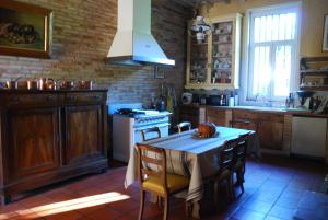 a kitchen with a table and a stove at Château Le Baudou in Coutras