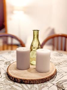 a table with two candles and a glass bottle at Lagoon in Sirmione +12 photos