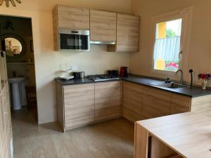 a kitchen with wooden cabinets and a counter top at VIGORSO 41 COUNTRY HOUSE in Budrio