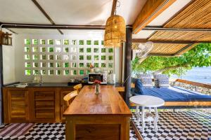 a kitchen with a table and a view of the ocean at Cookies Salad Resort in Salad Beach
