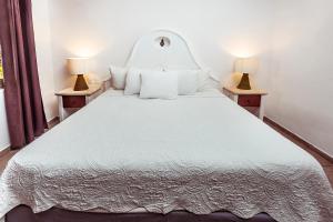 Postel nebo postele na pokoji v ubytování Fabiola Condo Hotel