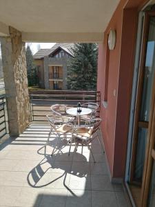 d'une terrasse avec une table et des chaises sur un balcon. dans l'établissement Daniella Apartman, à Bükfürdő