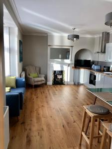 a living room with a blue couch and a fireplace at Stunning 2 Bed Georgian Apartment in Swafield