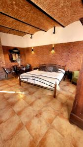 a large bed in a room with a brick wall at Studio Colonial in Rumburk
