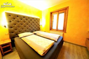מיטה או מיטות בחדר ב-Residence Casa Longa