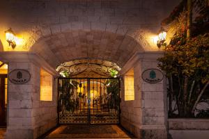 an entrance to a building with a metal gate at Fabiola Condo Hotel in Playa del Carmen