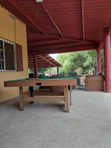 a ping pong table sitting under a pavilion with at BEAUTIFUL HOUSE IN LAS UVAS SAN CARLOS, PANAMA WITH FRUIT TREES -SWIMMING POOL in Las Uvas