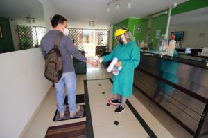 a man and a woman in scrubs standing in a pharmacy at HOSTAL CORAL in Ilo