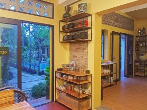 a room with a wall with a shelf with items at Mai Home Ninh Bình in Ninh Binh