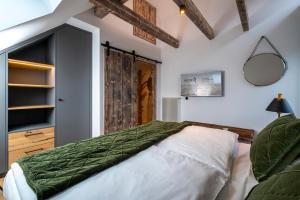 a bedroom with a large bed and a mirror at Apartment Suite - a57366 in Bad Segeberg
