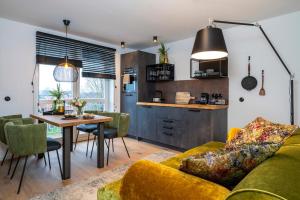 a living room with a yellow couch and a table at Apartment Suite - a57366 in Bad Segeberg