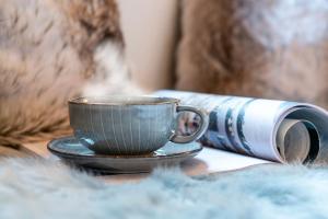 a cup of coffee on a table next to apiredpired book at Superior in Bad Segeberg