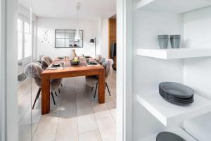 a dining room with a wooden table and chairs at Seehaus 48 in Norderney