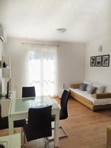 a living room with a table and chairs and a couch at lino in Ivan Dolac +31 photos