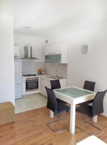 a kitchen with a table and chairs in a room at lino in Ivan Dolac