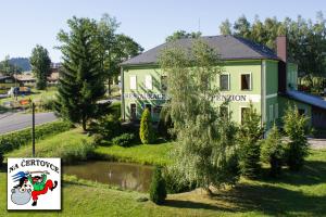 a house with a sign in front of it at Penzion na Čertovce in Dolní Orlice