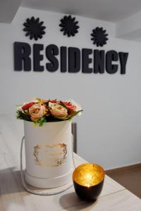 a white cake with flowers in it on a table at Pension Recidency in Oradea