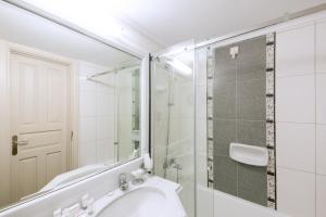 a bathroom with a glass shower and a sink at Kastello Hotel in Nafplio +106 photos