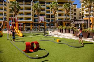 two children playing in a playground in a resort at Casa Dorada Los Cabos Resort & Spa in Cabo San Lucas