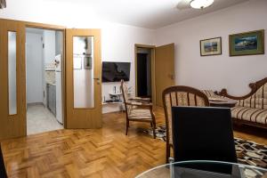a living room with a table with a laptop on it at Apartment Sole in Cetinje