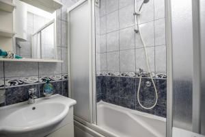 a bathroom with a shower and a sink and a toilet at Apartment Sole in Cetinje +18 photos