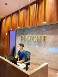 a man sitting in a chair with a laptop at Apartamento em Resort - Premium in Salinópolis +24 photos