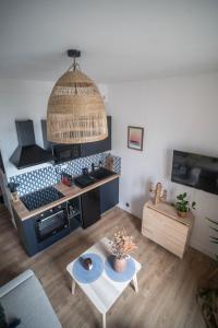 a kitchen with a stove and a table in a room at LITTLE BAHIA in Saint Malo