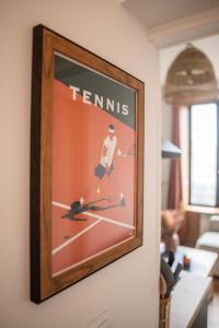 a framed picture of a tennis player on the wall at LITTLE BAHIA in Saint Malo