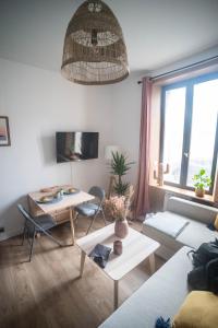 a living room with a couch and a table at LITTLE BAHIA in Saint Malo