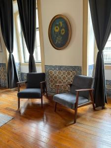 a waiting room with two chairs and curtains at Azulejos Cais Sodré B&B in Lisbon