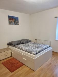Cama en habitación blanca con marco de cama en FeWo Teusch Top4, en Arnoldstein