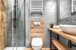 a bathroom with a shower and a toilet and a sink at MARGI Eos Apartament LARGE & BALCONY in Szczecin +16 photos