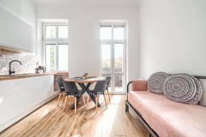 a living room with a couch and a table at MARGI Eos Apartament LARGE & BALCONY in Szczecin