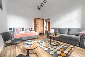 a living room with a couch and a table at MARGI Eos Apartament LARGE & BALCONY in Szczecin