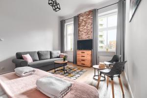 a living room with a bed and a couch at MARGI Eos Apartament LARGE & BALCONY in Szczecin