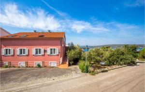 a red house on the side of a road at 2 Bedroom Beautiful Apartment In Punat in Punat