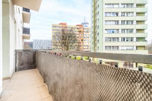 a balcony with a fence and some buildings at MARGI Eos Apartament LARGE & BALCONY in Szczecin