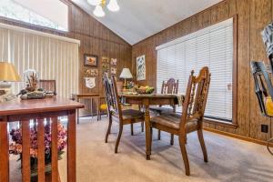 a dining room with a wooden table and chairs at 05210 - 8 South Pego Way in Hot Springs Village