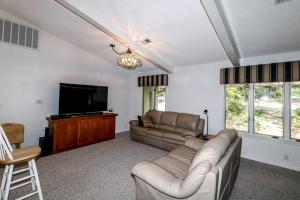 a living room with a couch and a flat screen tv at 05244 - 44 Pego Circle in Hot Springs Village