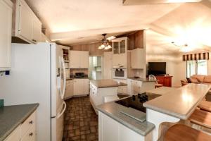 a kitchen with white cabinets and a white refrigerator at 05244 - 44 Pego Circle in Hot Springs Village