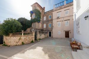 a large building with benches in front of it at Welcome Apartment - Old Town in Dubrovnik