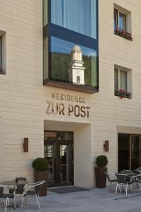 a building with a sign that reads residence zur post at Zur Post Residence Sexten in Sesto