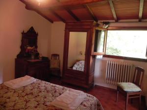 a bedroom with a mirror and a bed and a window at Lake Apartment in Villa Massi in Poggio Alla Croce +32 photos