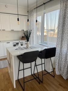 a kitchen with a table and two chairs and a window at Suburb stay by Overnight.ee in Petrikyula