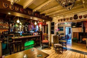 a pub with a bar with a green billiard at Manorbier Castle Inn Sunset Room in Tenby