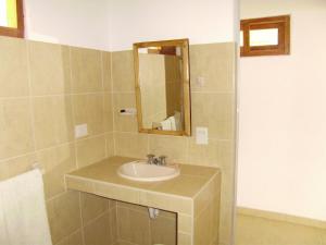 a bathroom with a sink and a mirror at El Gran Velero in Los Órganos
