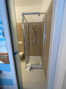 a shower in a bathroom with a glass door at La Casa di Greta in Camogli