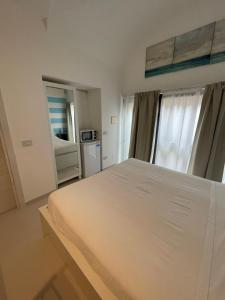 a bedroom with a white bed and a window at La Casa di Greta in Camogli +4 photos