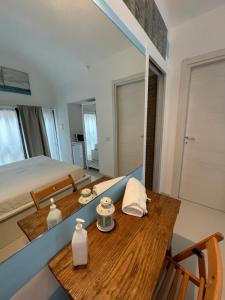 a bedroom with a bed and a table with a mirror at La Casa di Greta in Camogli