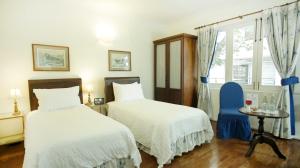 Postel nebo postele na pokoji v ubytování La Rabida Hotel Boutique